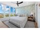 Serene bedroom with ocean views, a ceiling fan, and calming green and white decor at 1211 Gulf Of Mexico Dr # 401, Longboat Key, FL 34228