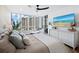 Coastal-themed bedroom with a large window, wall-mounted TV, and a view at 1211 Gulf Of Mexico Dr # 401, Longboat Key, FL 34228