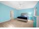 Large bedroom with blue walls, ceiling fan, and carpeted floors at 12259 23Rd E St, Parrish, FL 34219