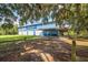 Blue community center nestled among trees, ideal for gatherings at 12259 23Rd E St, Parrish, FL 34219