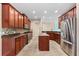 Modern kitchen featuring stainless steel appliances, a center island, and wood cabinetry at 12259 23Rd E St, Parrish, FL 34219