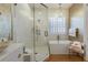 Spa-like bathroom with soaking tub, glass shower, and designer wallpaper at 1923 Hibiscus St, Sarasota, FL 34239