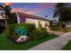 Landscaped home exterior at sunset with string lights at 1923 Hibiscus St, Sarasota, FL 34239