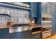 Modern kitchen with blue cabinetry, a statement backsplash, and a large island at 1923 Hibiscus St, Sarasota, FL 34239