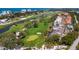 Aerial view of the golf course with water features, nearby residences, and lush greenery at 2215 Harbourside Dr # 304, Longboat Key, FL 34228