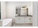 Elegant bathroom with double vanity, soaking tub, and modern fixtures at 224 Corelli Dr, Nokomis, FL 34275