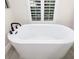 Luxurious soaking tub with black fixtures and white finish at 224 Corelli Dr, Nokomis, FL 34275