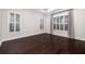 Spacious bedroom with dark hardwood floors and window with plantation shutters at 224 Corelli Dr, Nokomis, FL 34275