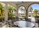 Outdoor seating area with tables and chairs overlooking pool at 224 Corelli Dr, Nokomis, FL 34275