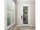 Bright entryway with a white door and plantation shutters at 224 Corelli Dr, Nokomis, FL 34275