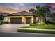 Two-story home with three-car garage and landscaping at 224 Corelli Dr, Nokomis, FL 34275