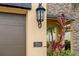 Two-car garage with a sleek design and modern lighting fixture at 224 Corelli Dr, Nokomis, FL 34275