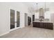 Open concept kitchen with dark wood island and stainless steel appliances at 224 Corelli Dr, Nokomis, FL 34275