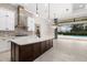 Open kitchen with large island and access to backyard pool at 224 Corelli Dr, Nokomis, FL 34275
