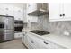 Modern kitchen with stainless steel appliances and white cabinetry at 224 Corelli Dr, Nokomis, FL 34275