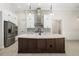 Modern kitchen with a large island, white cabinets, and quartz countertops at 224 Corelli Dr, Nokomis, FL 34275