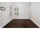 Empty office space with dark hardwood floors and white walls at 224 Corelli Dr, Nokomis, FL 34275