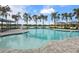 Community pool with cabanas and plenty of lounge chairs at 224 Corelli Dr, Nokomis, FL 34275