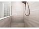 Large walk-in shower with grey tile and built-in bench at 224 Corelli Dr, Nokomis, FL 34275