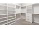 Large walk-in closet with hanging rods and shelving units at 224 Corelli Dr, Nokomis, FL 34275
