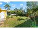 Spacious backyard with a storage shed, fire pit area, and lush landscaping at 2481 W Milmar Dr, Sarasota, FL 34237