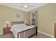 Bedroom with wooden bedframe, nightstands, and large window with natural light at 2520 Terracina Dr, Venice, FL 34292