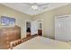 Another view of the bedroom showcasing the closet, dresser, and ensuite bathroom access at 2520 Terracina Dr, Venice, FL 34292