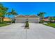 Front view of the home featuring a two-car garage and a paved driveway at 2520 Terracina Dr, Venice, FL 34292