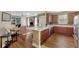 Open-concept kitchen and living area with wood flooring and breakfast bar at 2520 Terracina Dr, Venice, FL 34292