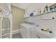 Laundry room with washer, dryer, sink, and ample storage space at 2520 Terracina Dr, Venice, FL 34292