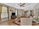 The living room showcases comfortable seating, a TV, and wood floors at 2520 Terracina Dr, Venice, FL 34292