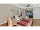 The spacious living room features a ceiling fan, large windows, hardwood floors, and backyard access at 2520 Terracina Dr, Venice, FL 34292