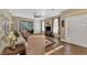 The well-lit living room offers comfortable furniture, wood floors, and views of the backyard at 2520 Terracina Dr, Venice, FL 34292