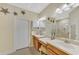 Spacious main bathroom with double vanity, large mirror, and walk-in shower at 2520 Terracina Dr, Venice, FL 34292
