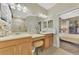 Main bathroom featuring dual sinks, vanity stool, and view of the bedroom at 2520 Terracina Dr, Venice, FL 34292