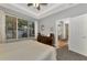 Primary bedroom with large windows, plush carpet, and ensuite bathroom access at 2520 Terracina Dr, Venice, FL 34292