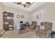Home office or den with built-in bookshelf, desk, and comfortable seating at 2520 Terracina Dr, Venice, FL 34292