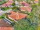 Aerial close-up of the home's terracotta roof and surrounding trees at 2520 Terracina Dr, Venice, FL 34292