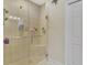Walk-in shower with glass door, tile walls, and built-in bench at 2520 Terracina Dr, Venice, FL 34292