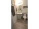 Bathroom with single vanity, toilet, and updated flooring at 3333 26Th E Ave # 1107, Bradenton, FL 34208