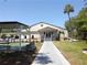 Community clubhouse entrance with shuffleboard court and covered area at 3333 26Th E Ave # 1107, Bradenton, FL 34208