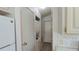 Hallway with a stacked washer and dryer unit and a door at the end of the hallway at 3333 26Th E Ave # 1107, Bradenton, FL 34208