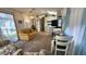 Open-concept living area with a sofa, dining table, and view of the kitchen at 3333 26Th E Ave # 1107, Bradenton, FL 34208