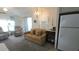 Living room with a sofa, recliners, and a view of the kitchen at 3333 26Th E Ave # 1107, Bradenton, FL 34208
