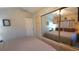 Main bedroom with mirrored closet doors and ceiling fan at 3333 26Th E Ave # 1107, Bradenton, FL 34208