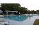 Community pool with covered seating and lounge chairs at 3333 26Th E Ave # 1107, Bradenton, FL 34208