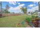 Spacious backyard with lush green lawn, a storage shed, and a wooden fence at 345 Glen Oak Rd, Venice, FL 34293