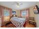 Bedroom with a floral-patterned bedspread, nightstand, and chair at 345 Glen Oak Rd, Venice, FL 34293