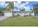 Inviting front exterior with palm trees, a driveway, and a neatly maintained lawn at 345 Glen Oak Rd, Venice, FL 34293