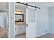 Bathroom features a granite countertop, tiled floors, and a sliding barn door at 3468 51St Avenue W Dr, Bradenton, FL 34210